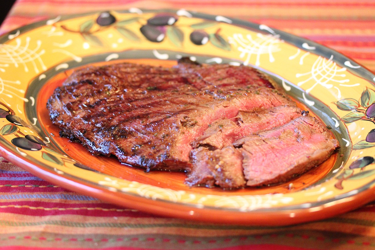 Grilled steak on a platter and sliced