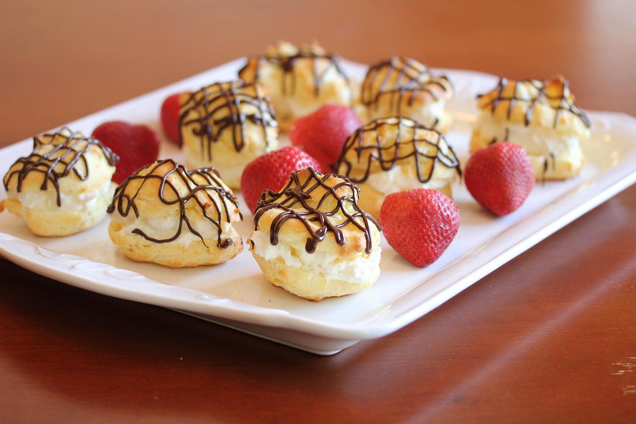 plated cream puffs garnished with strawberries