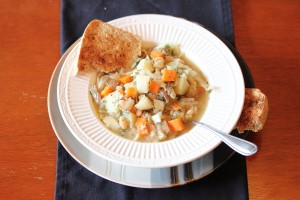 overhead picture of bowl of ham and bean soup with side of crusty bread