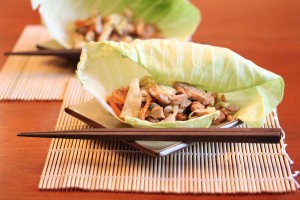 side picture of mu shu pork wrap on plate with chop sticks