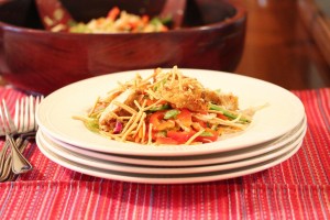 Asian salad on a plate and that plate is on top of other plates