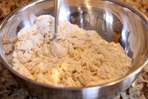 what the dough looks like once the egg and the flour have been incorporated, but not yet ready to form a ball