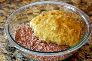 Cake mix and bananas in a bowl before mixing together