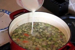 Pouring the milk and flour slurry into the soup