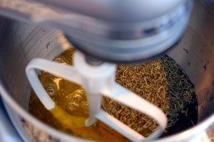 Wet ingredients and rosemary in the stand mixer bowl