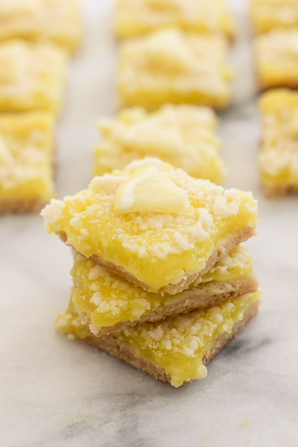 Sliced lemon bars garnished with fresh lemon