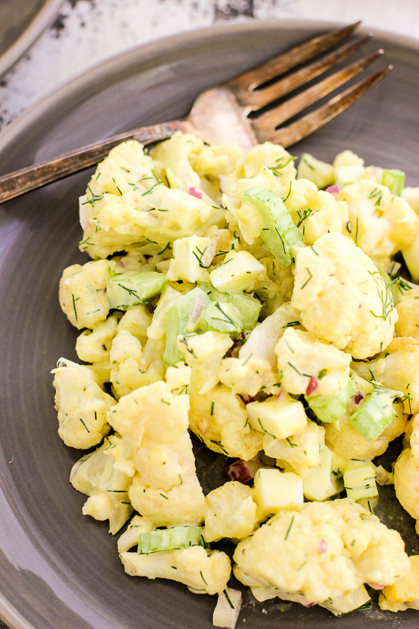 Over head photo of cauliflower dill no potato salad served on a salad plate.